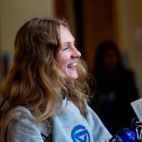 A Thompson Scholar holding on to a water bottle that she received.